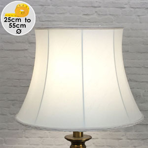A traditional styled drum lamp shade that is bowed in the middle in white faux silk